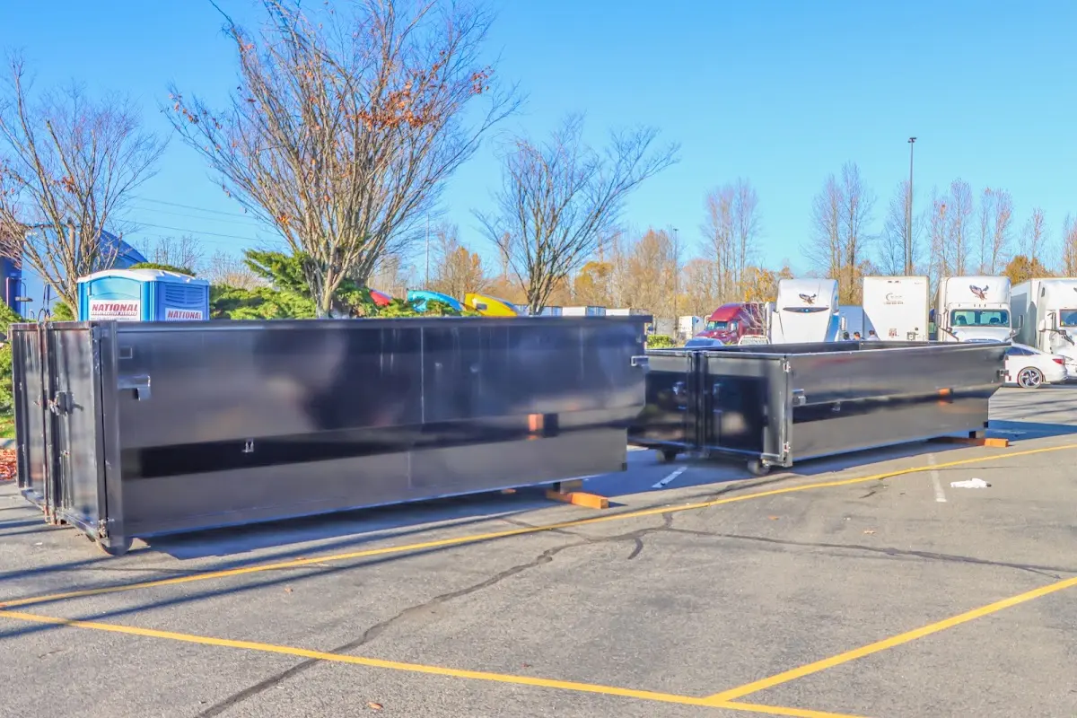 Professional dumpster rental service with roll-off container on residential driveway in Walworth